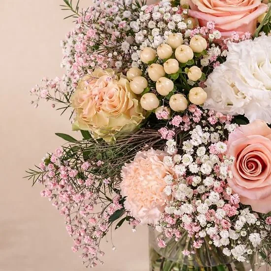 Detail of peach roses, hypericum berries and pink and white gypsophila